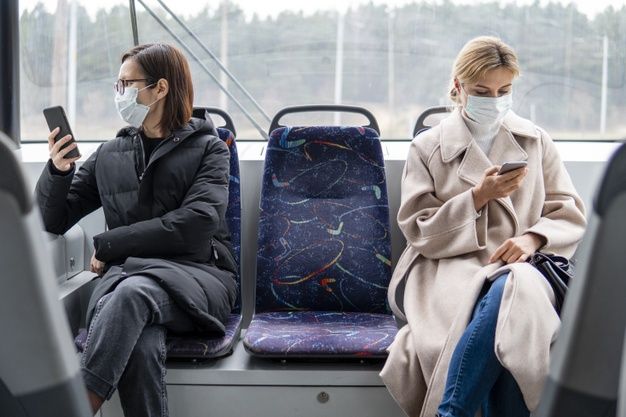 young women using public transport with surgical mask 23 2148454309